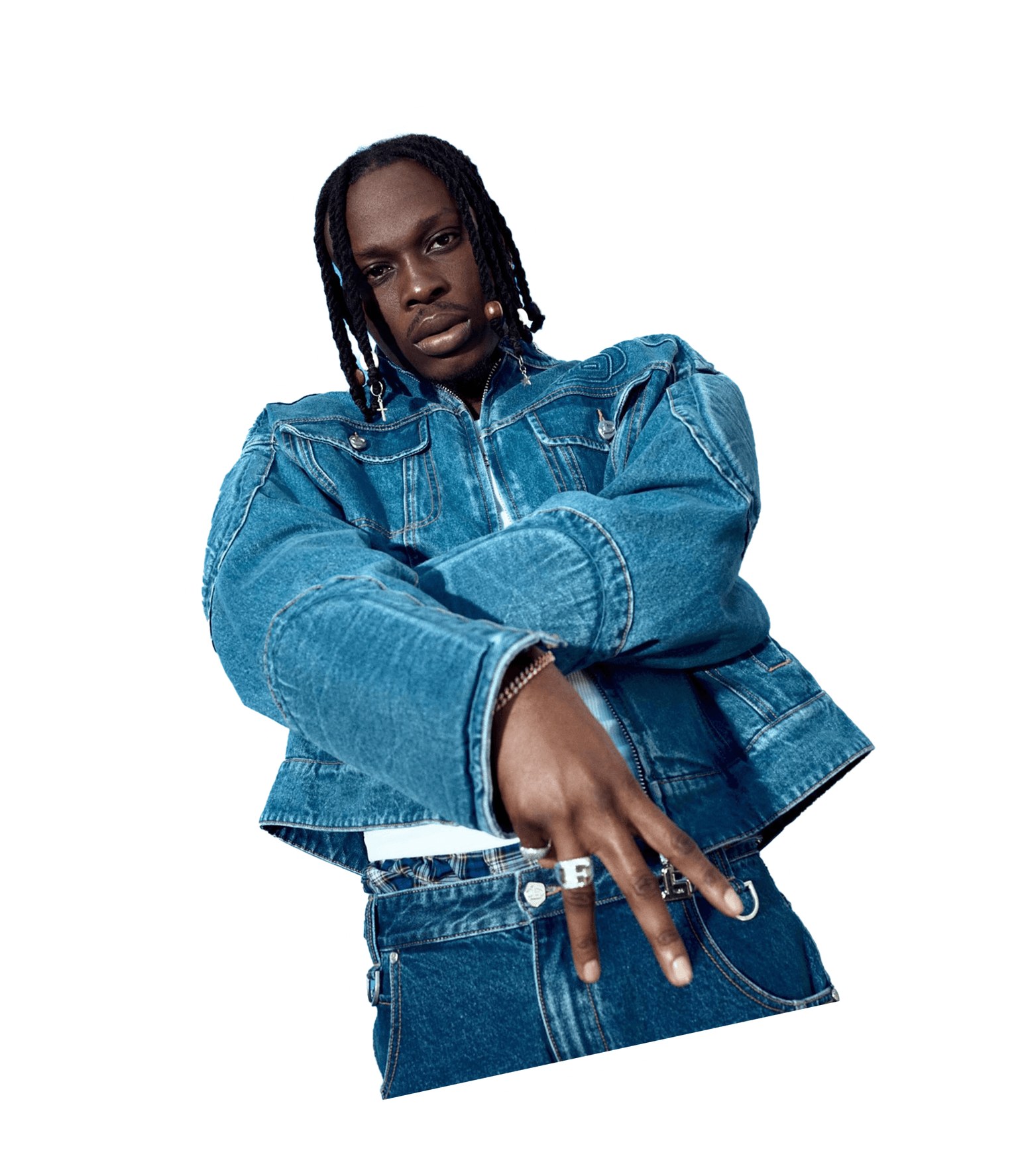 Fireboy DML is a jean jacket, folding left hand under right and holding three fingers out on the right hand.